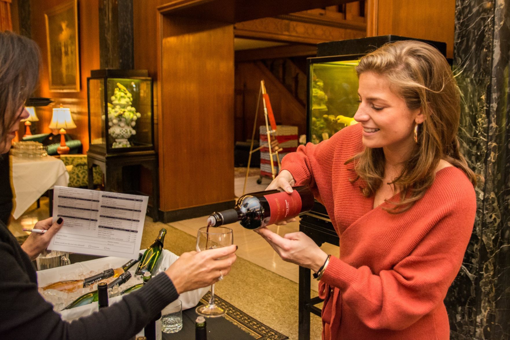 Kendall Kraus, representing Louis M. Martini and J. Vineyards pours a glass of wine for an attendee
